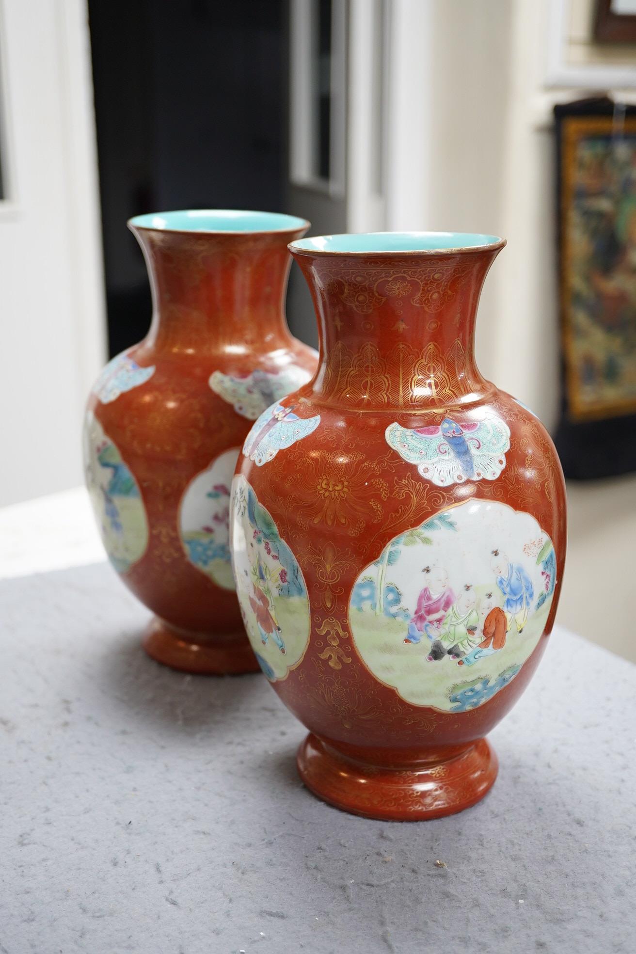 A pair of Chinese coral ground ‘boys’ vases, Jiaqing period (1796-1820)